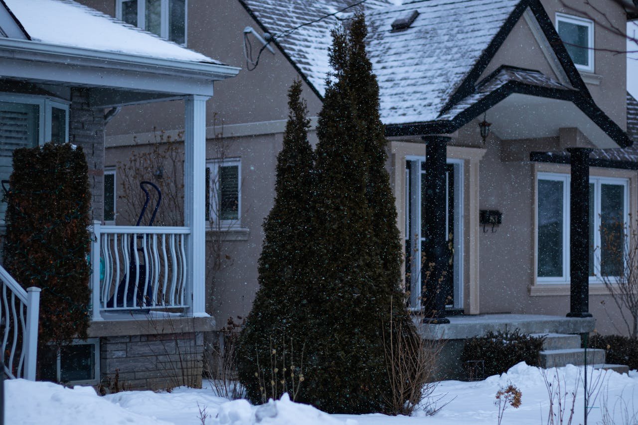 Mastering the First Impression: Your intriguing post title goes here Charming Toronto house covered in snow during a serene Canadian winter day.